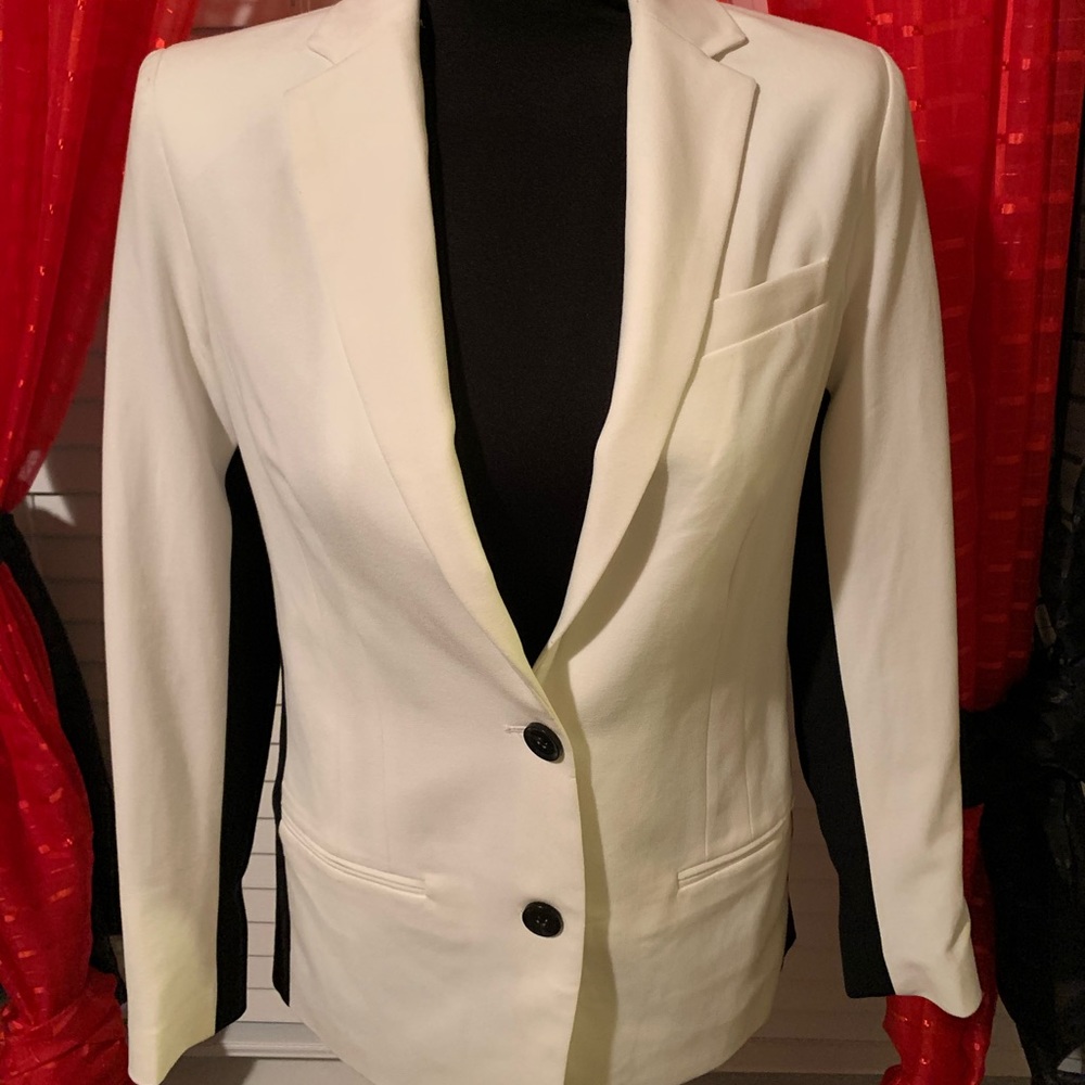 White and black blazer.